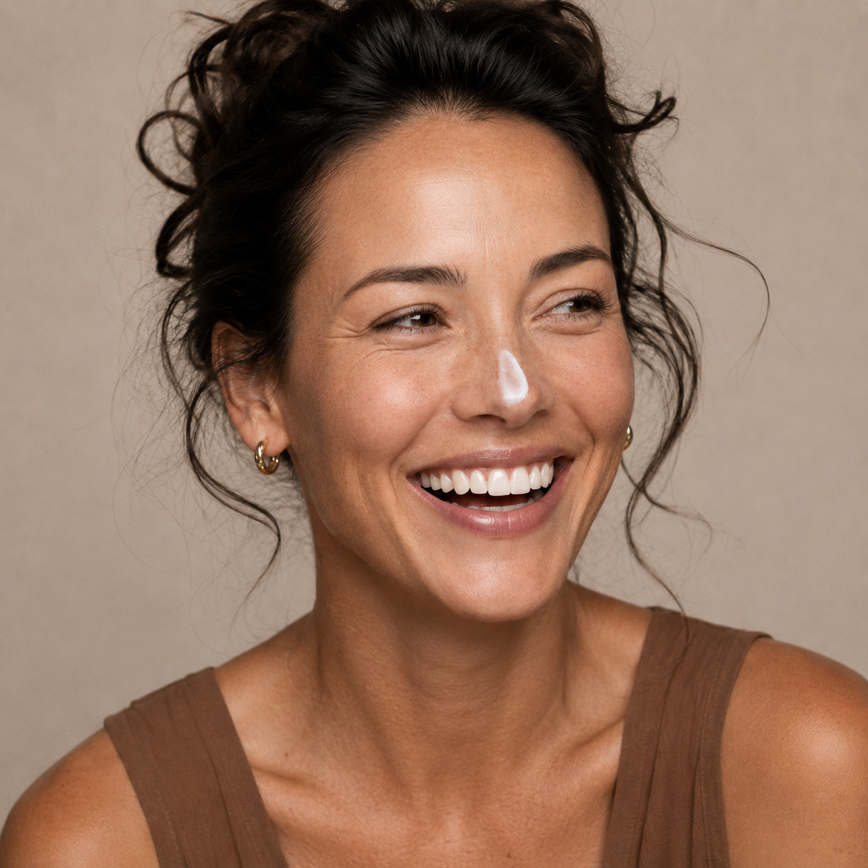 Model with a texture Skinmoods Nourishing Night Cream  on her nose smiling