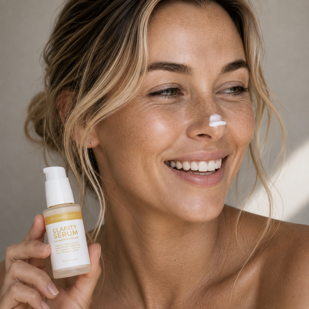 Model with Skinmoods Clarity Serum on her nose and bottle in her hand